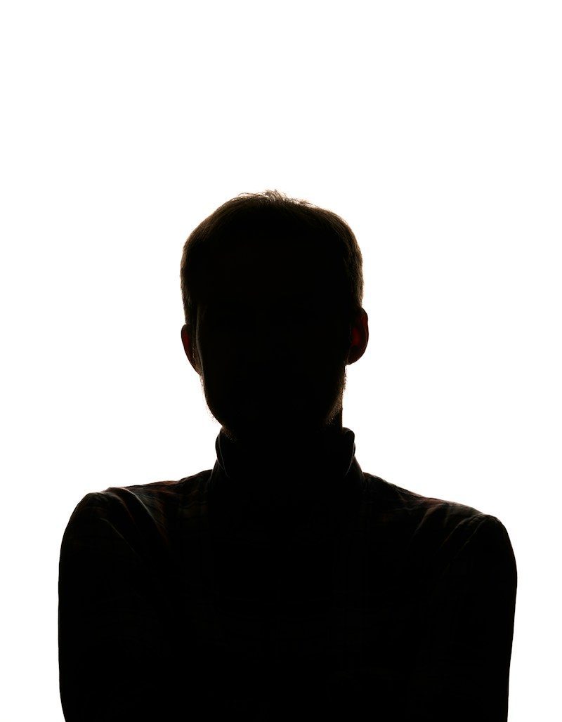 a silhouette of a man with his arms crossed